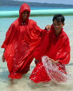 wet swimming poncho in the water